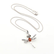 Silver necklace with a dragonfly pendant on a white background