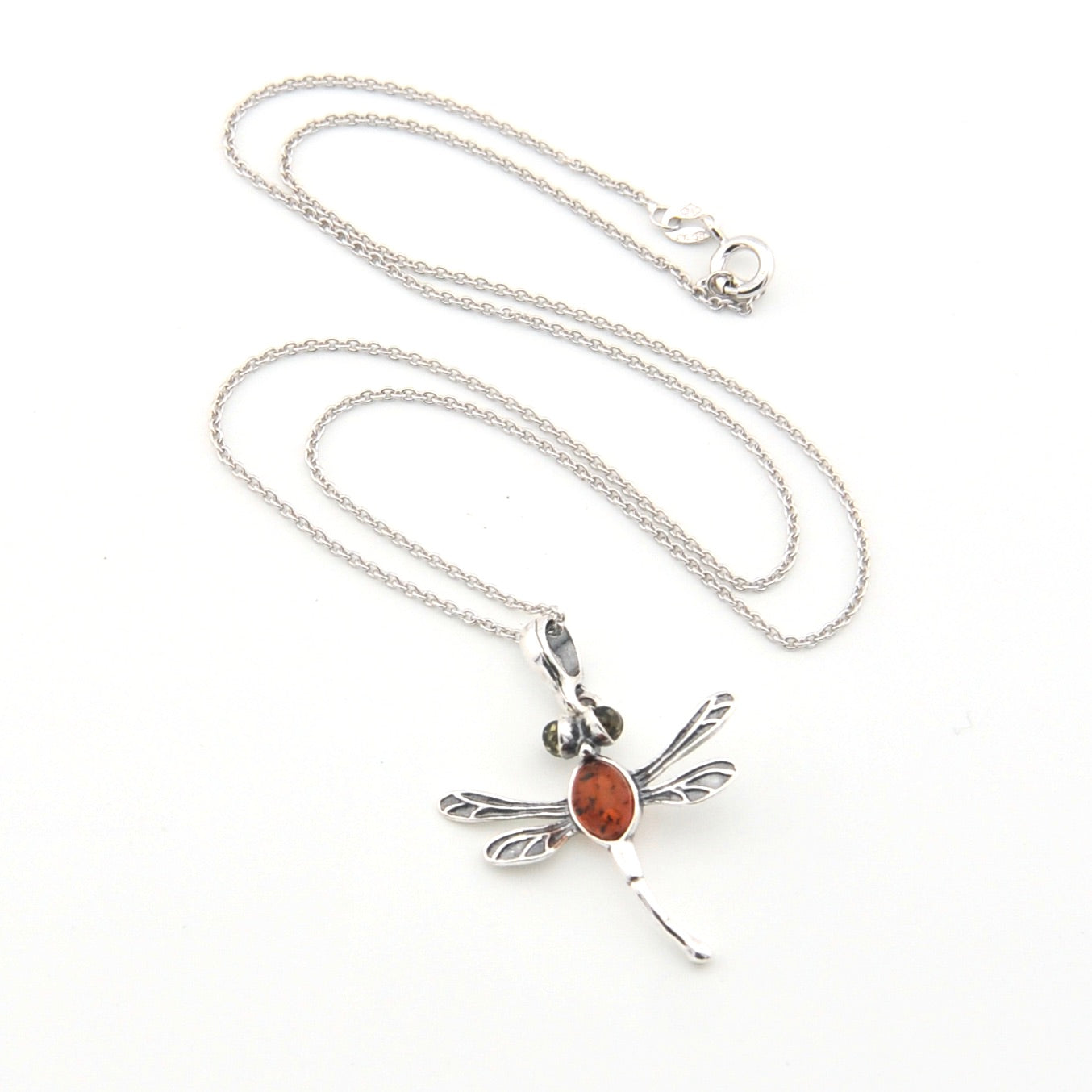 Silver necklace with a dragonfly pendant on a white background