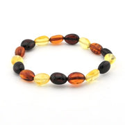 A beaded stretch bracelet made of polished oval beads in amber orange, translucent yellow, and dark brown, arranged in a circle on a white background.