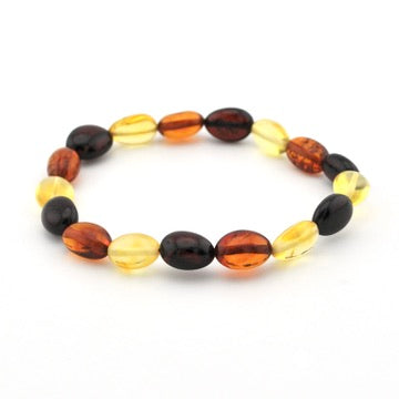 A beaded stretch bracelet made of polished oval beads in amber orange, translucent yellow, and dark brown, arranged in a circle on a white background.