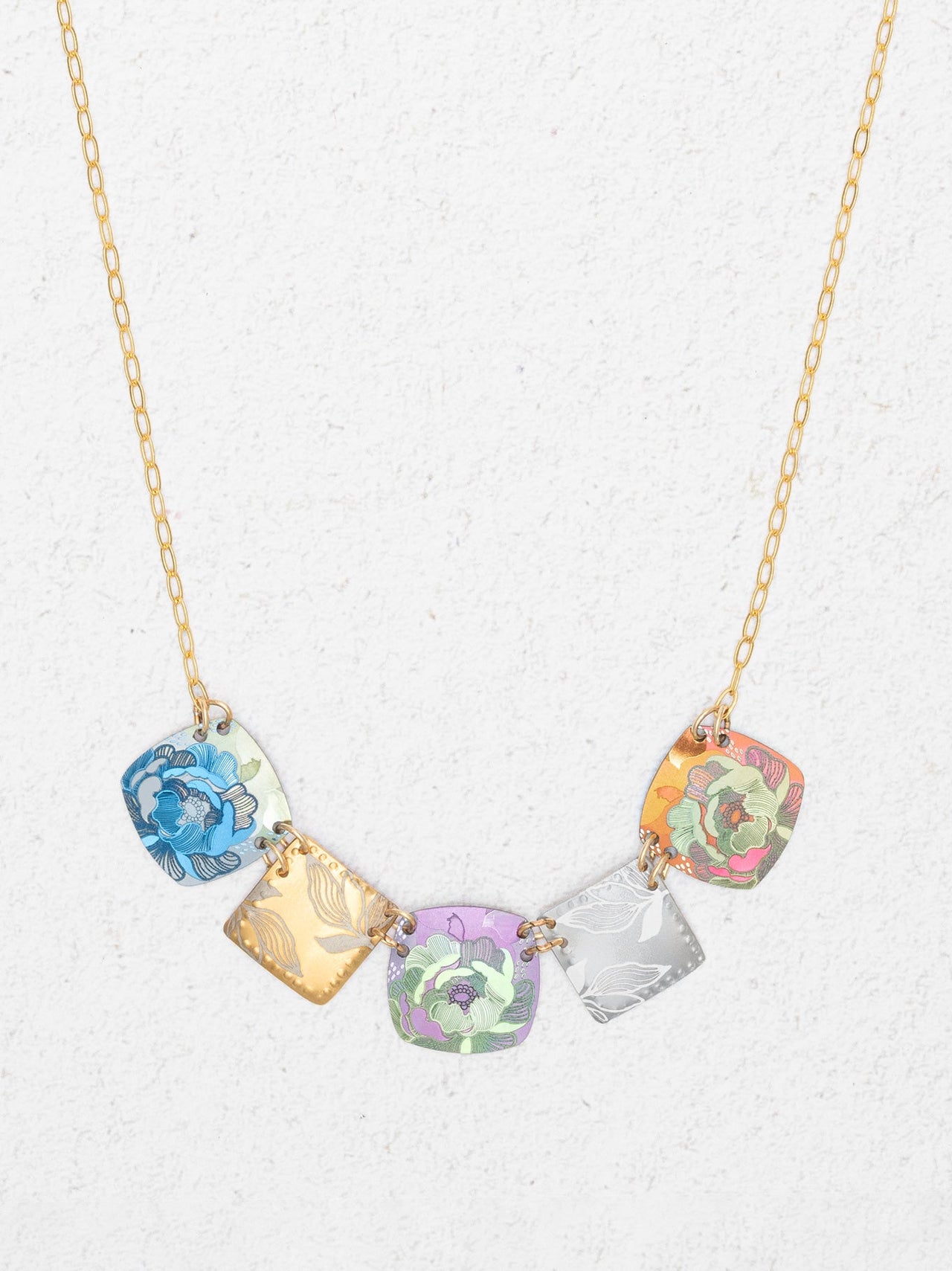 Necklace with colorful square pendants on a white background