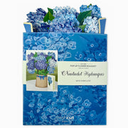 Blue floral pop-up bouquet with packaging and card on a white background