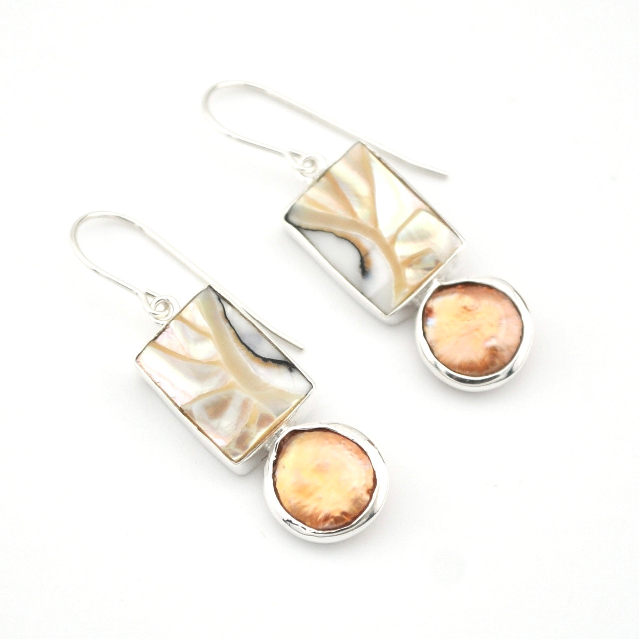 Pair of earrings with gold and silver designs on a white background