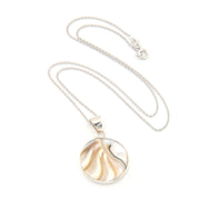 Silver necklace with a round pendant on a white background