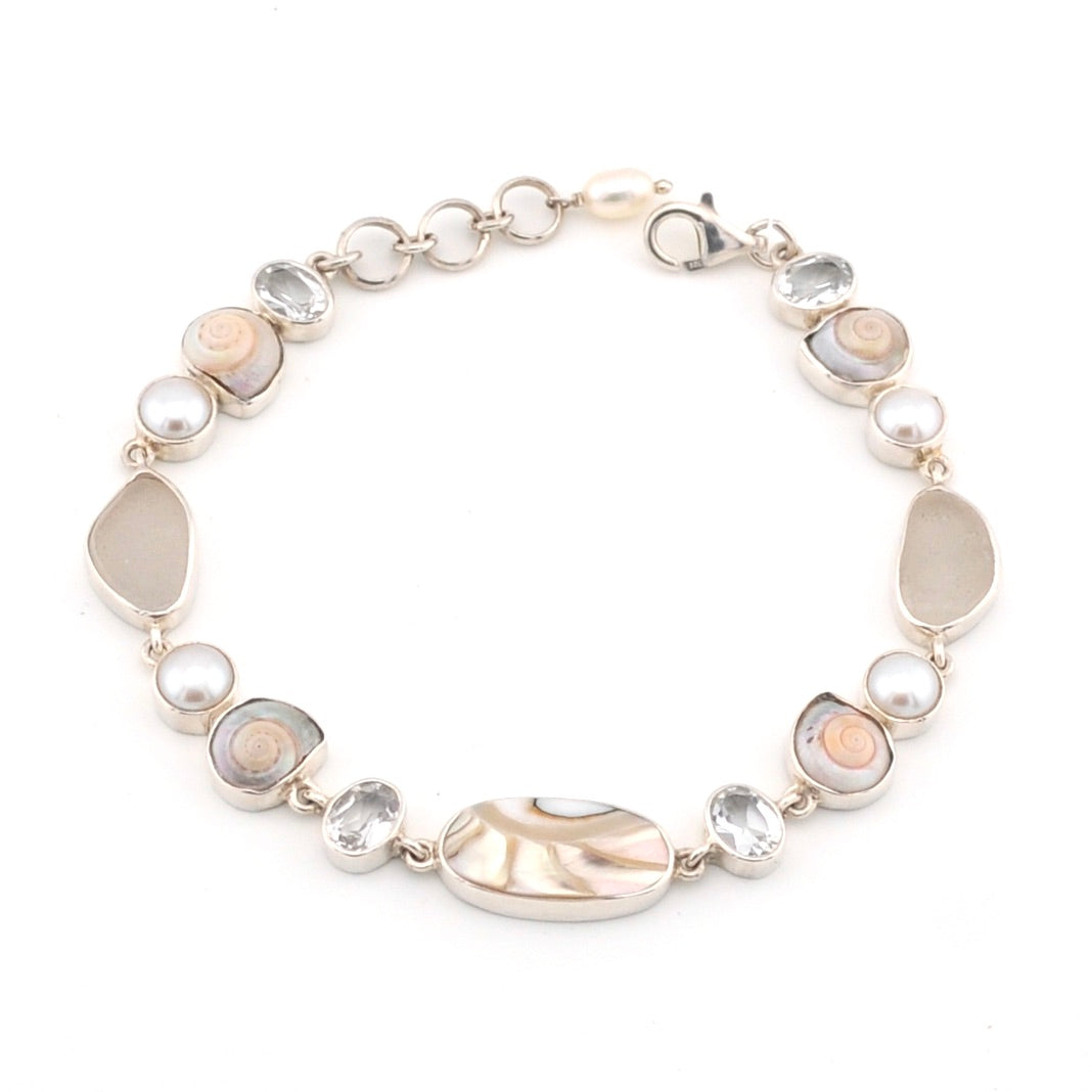 Bracelet with shells, pearl, white topaz on a white background