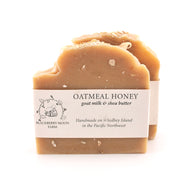 Bar of oatmeal honey soap with a label on a white background
