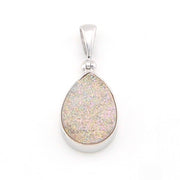 Teardrop-shaped pendant with a textured surface on a white background