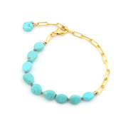 Gold bracelet with turquoise beads on a white background