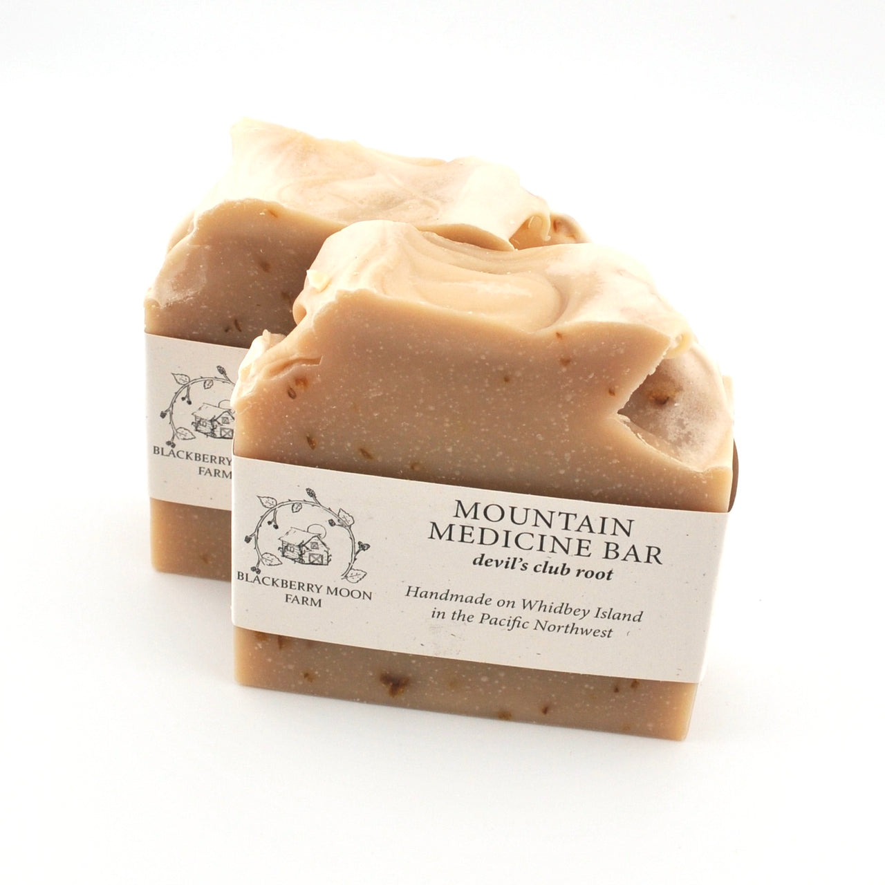 Two soap bars with labels on a white background
