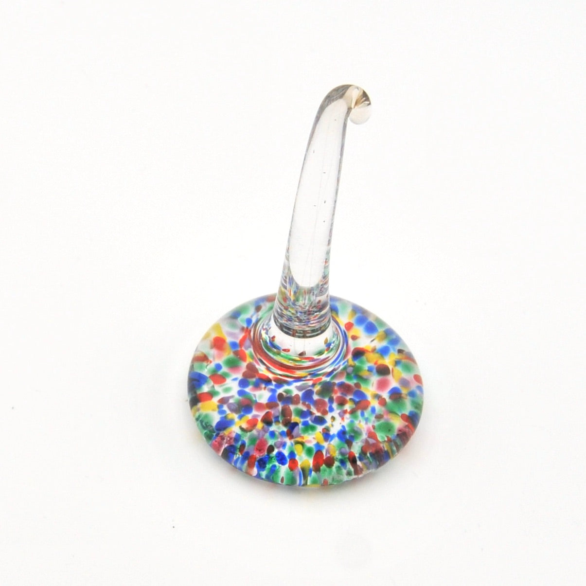 Multicolored speckled glass ring holder on a white background