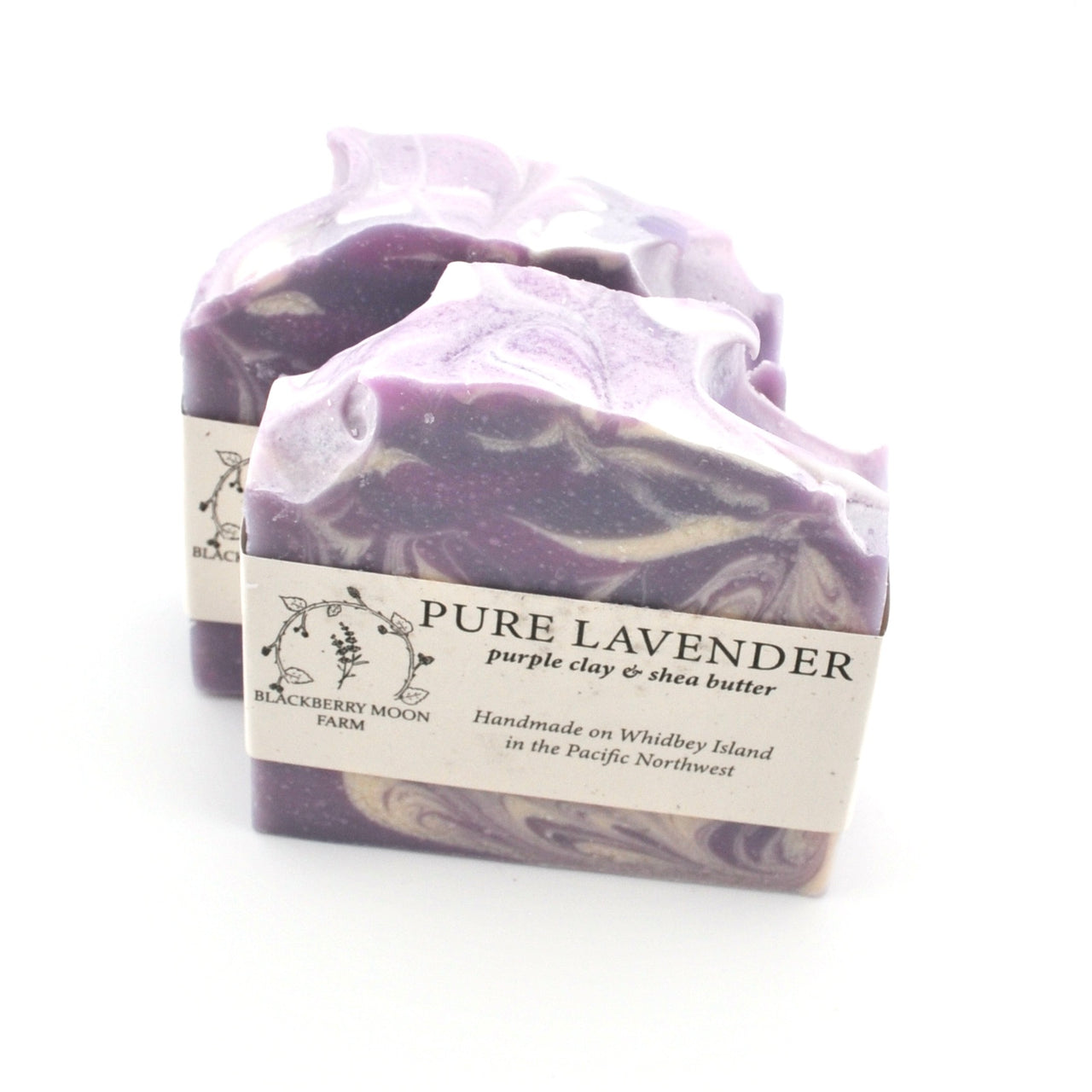 Purple and white marbled soap with a label on a white background