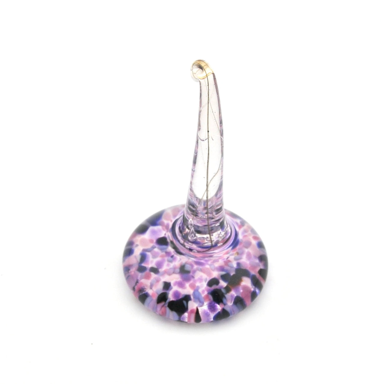 Glass ring holder with purple and black speckled base on a white background