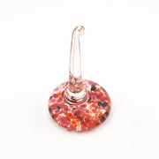 Decorative glass ring holder with a colorful base on a white background