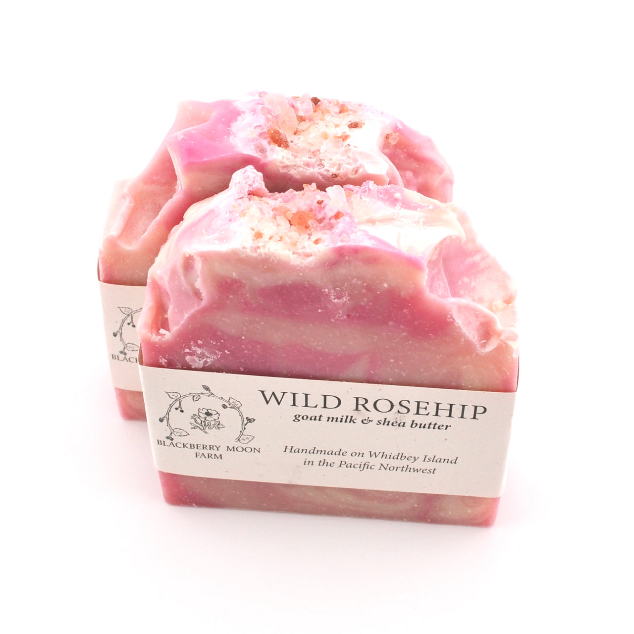 Pink soap bar with a label on a white background