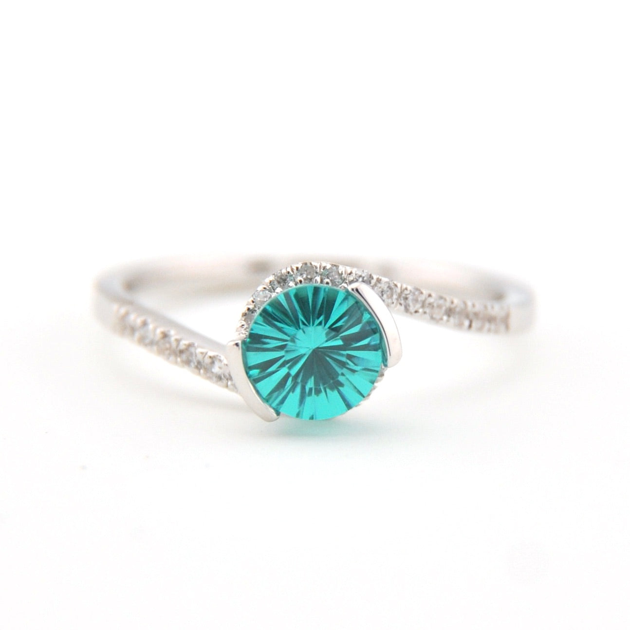 Silver ring with a teal gemstone on a white background