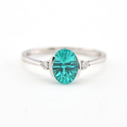 Silver ring with a teal gemstone on a white background