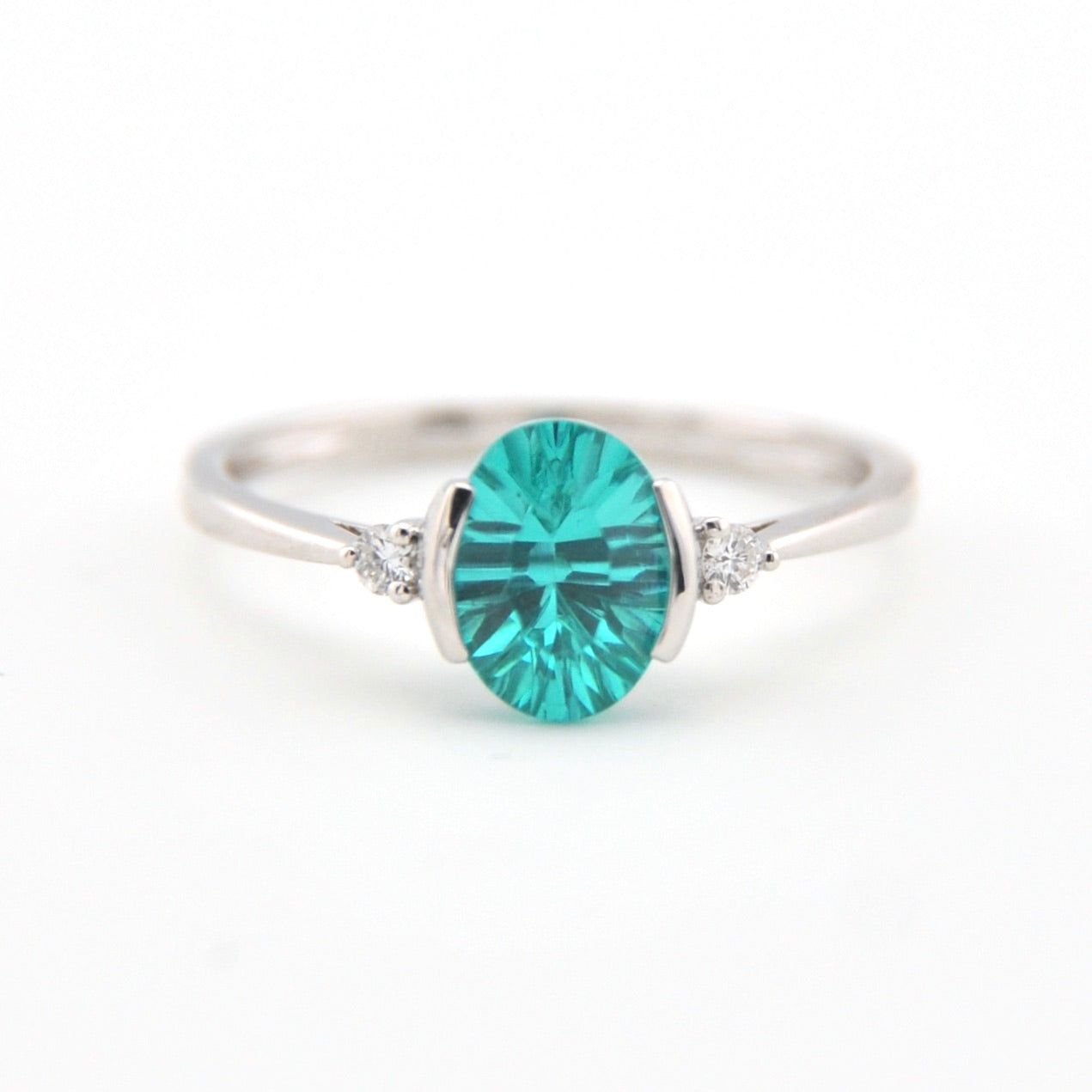 Silver ring with a teal gemstone on a white background