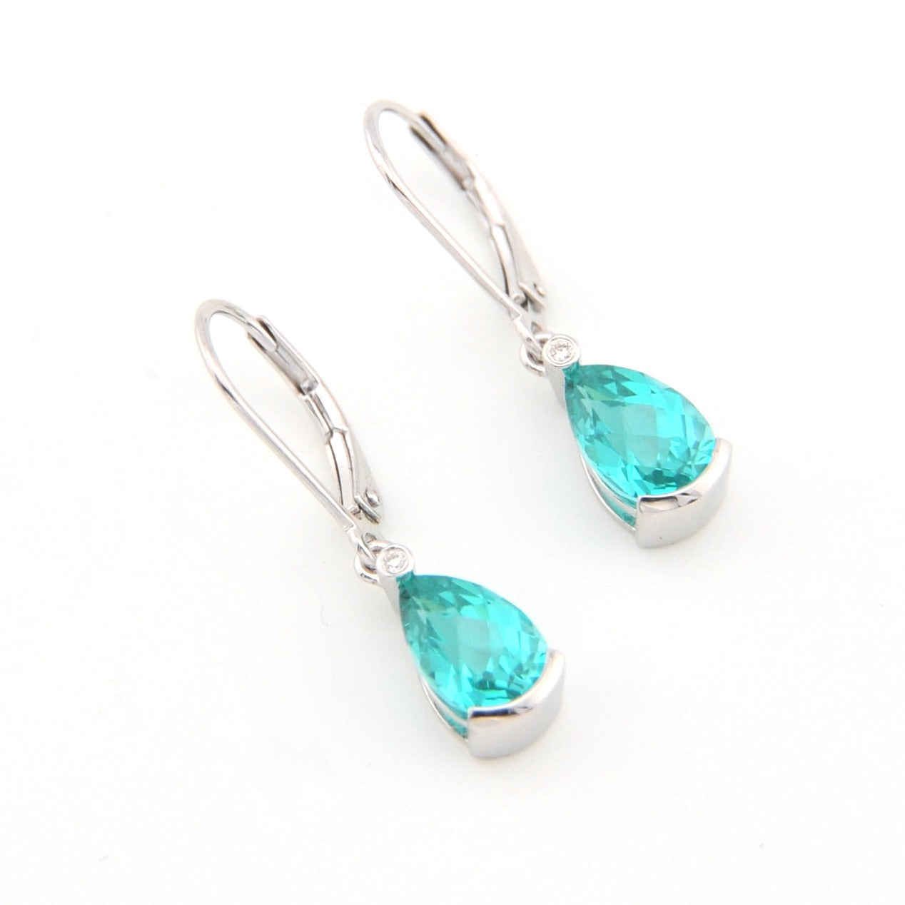 Pair of teal teardrop earrings on a white background