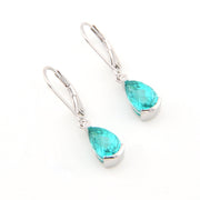 Pair of teal teardrop earrings on a white background