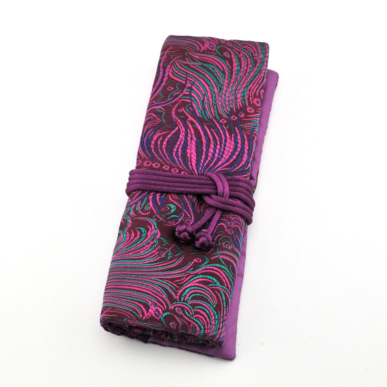 Folded fabric with purple and pink pattern on a white background