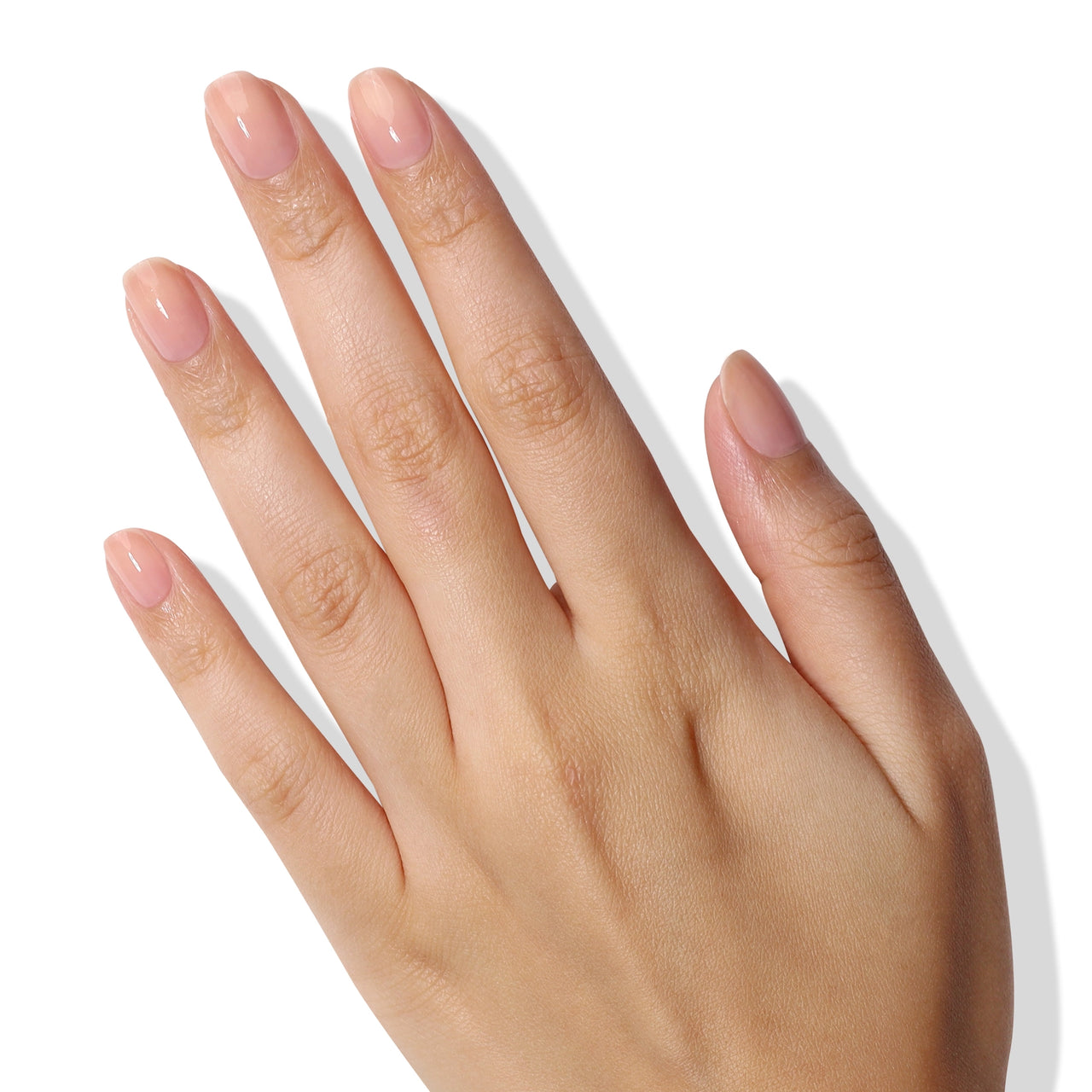 Hand with light pink nail polish on a white background