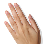 Hand with light pink nail polish on a white background