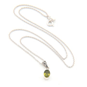 Silver necklace with a green pendant on a white background