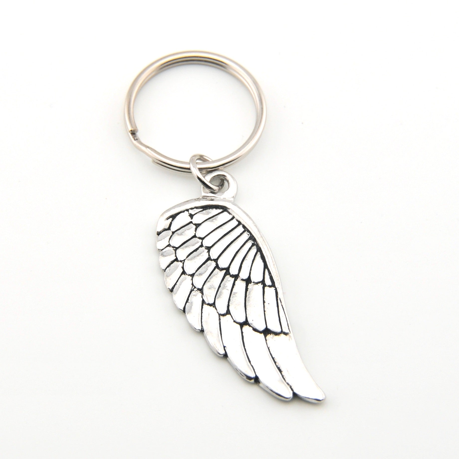 Silver angel wing keychain on a white background