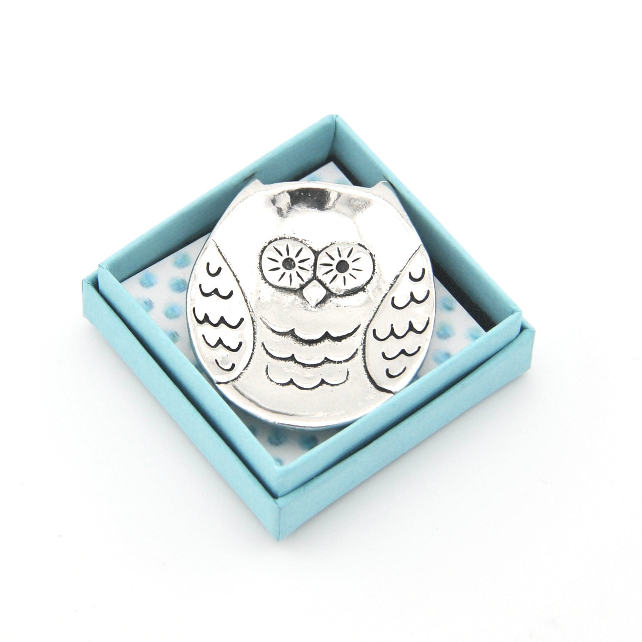 Silver owl-shaped object in a light blue box on a white background