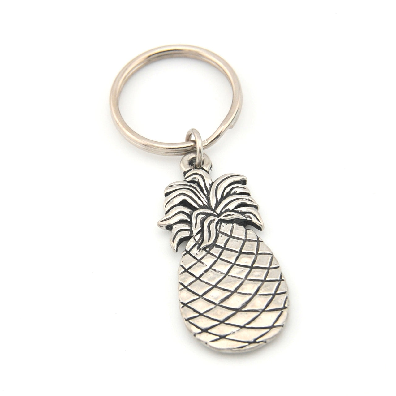 Silver pineapple keychain on a white background
