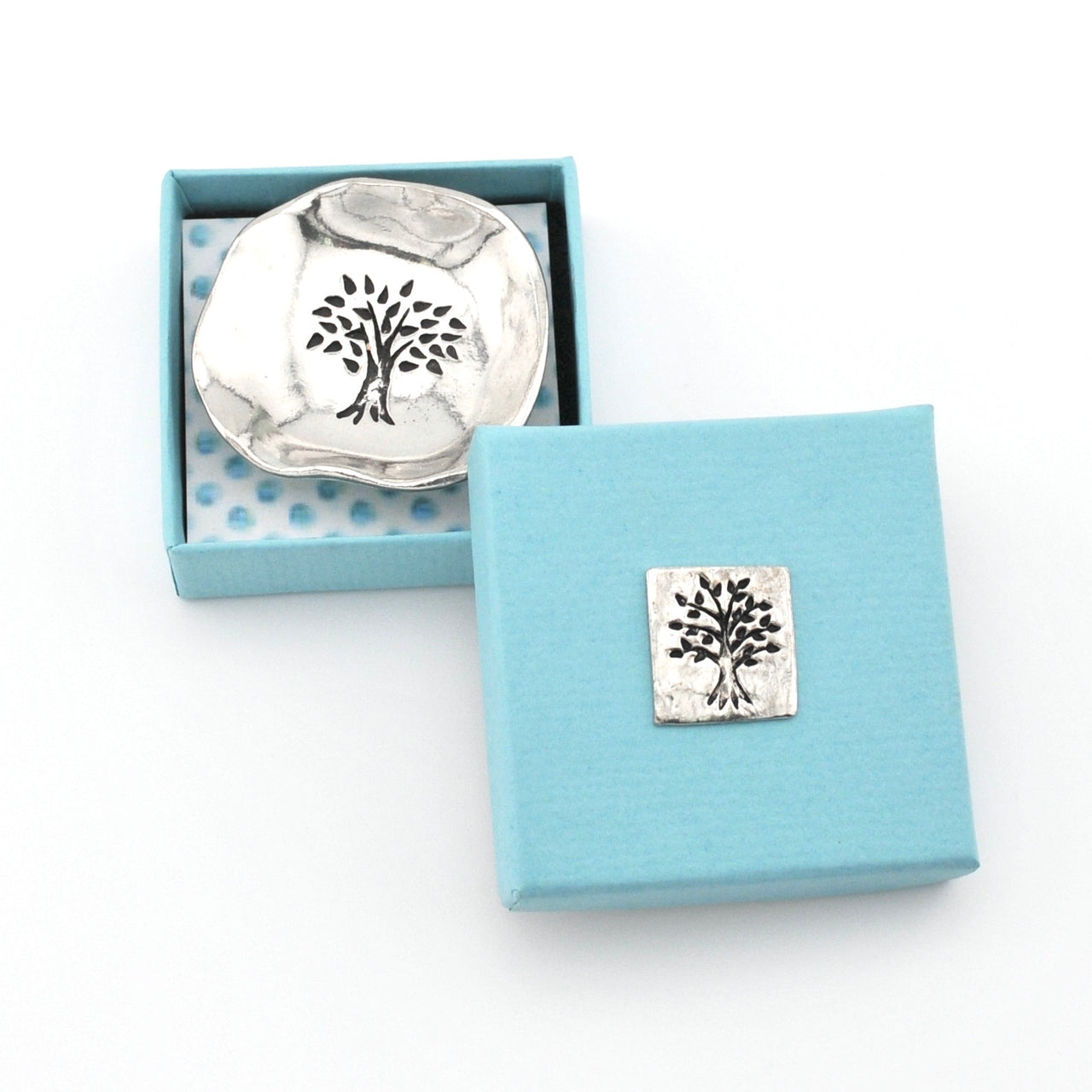 Silver tree-shaped object in a blue box with a white background