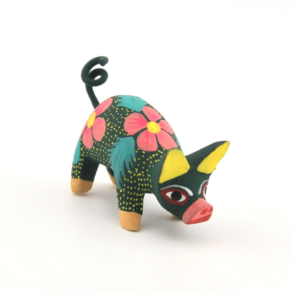 Colorful pig figurine with floral patterns on a white background