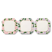 Three square plates with floral border designs on a white background
