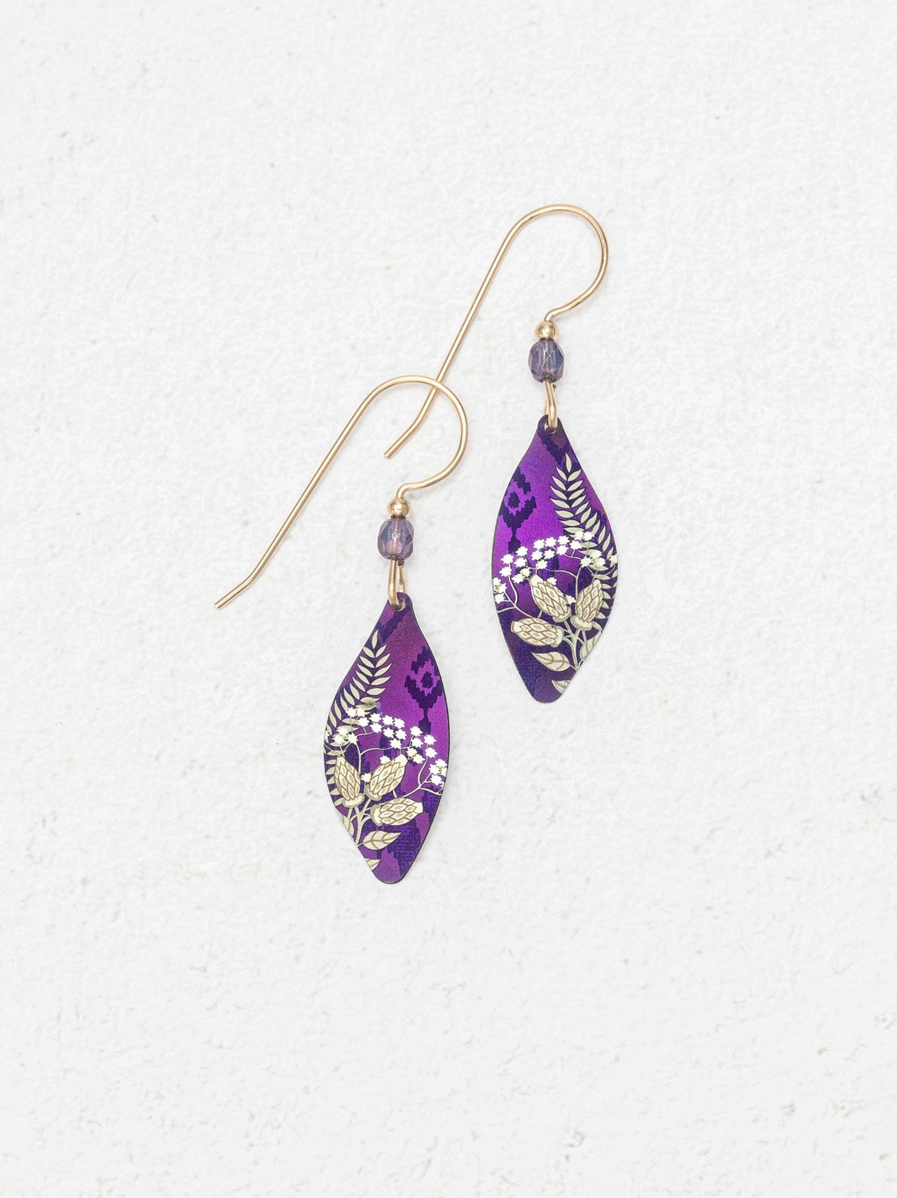 Purple floral earrings on a white background