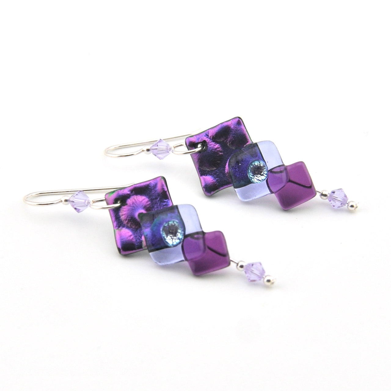 Pair of purple and pink square-shaped earrings on a white background