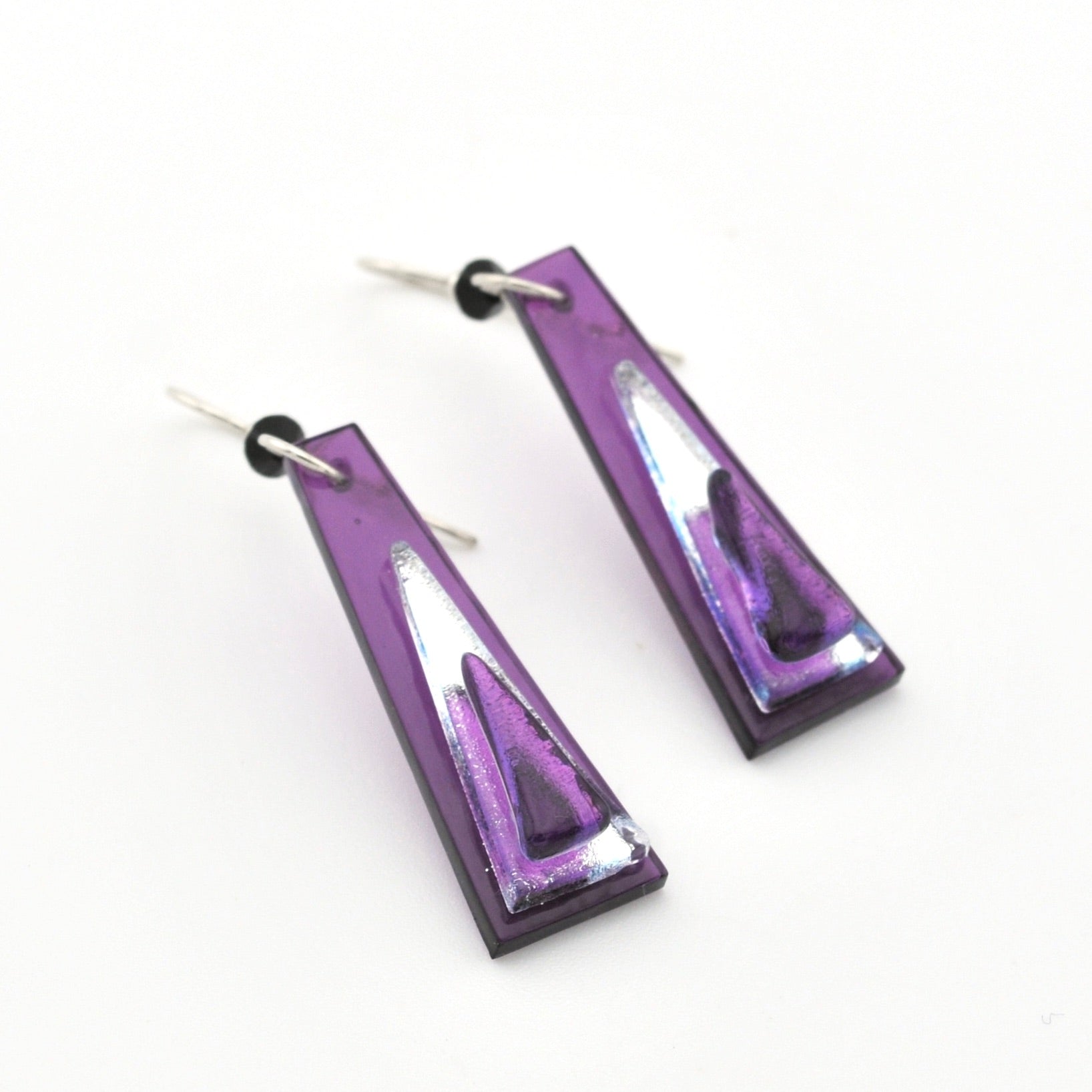 Purple and silver geometric earrings on a white background