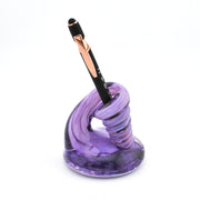 Purple pen holder with a pen on a white background