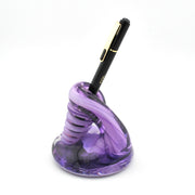 Purple spiral pen holder with a black pen on a white background