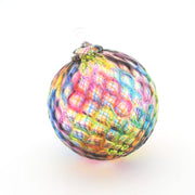 Multicolored glass ornament on a white background