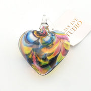Colorful glass heart ornament with 'Glass Eye Studio' branding on a white background