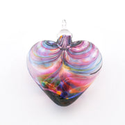 Multicolored glass heart ornament on a white background
