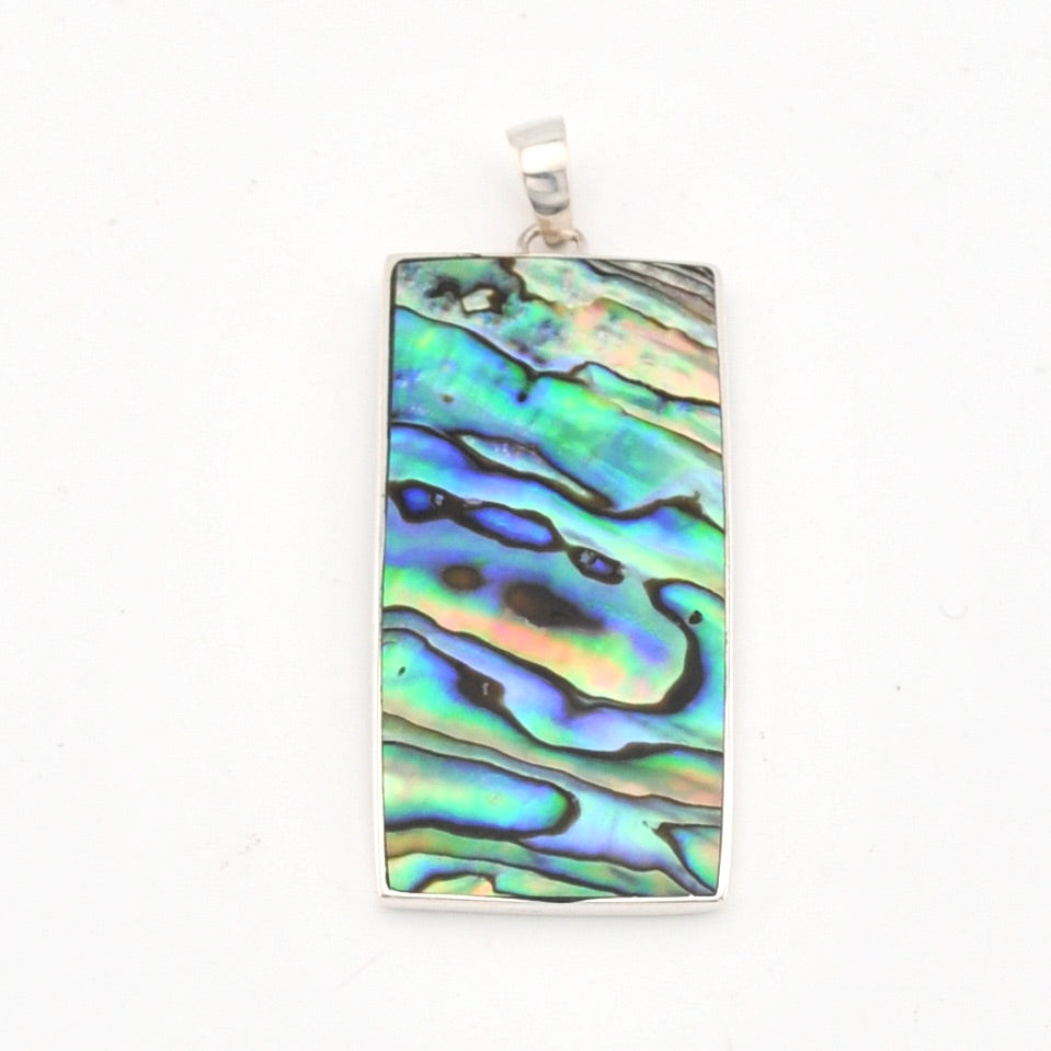 Rectangular pendant with colorful shell pattern on a white background