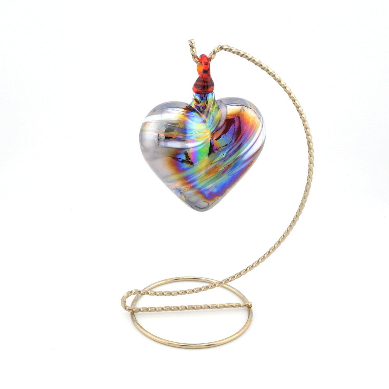 Heart-shaped glass pendant on a chain against a white background