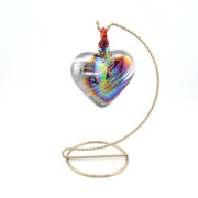 Heart-shaped glass pendant on a chain against a white background