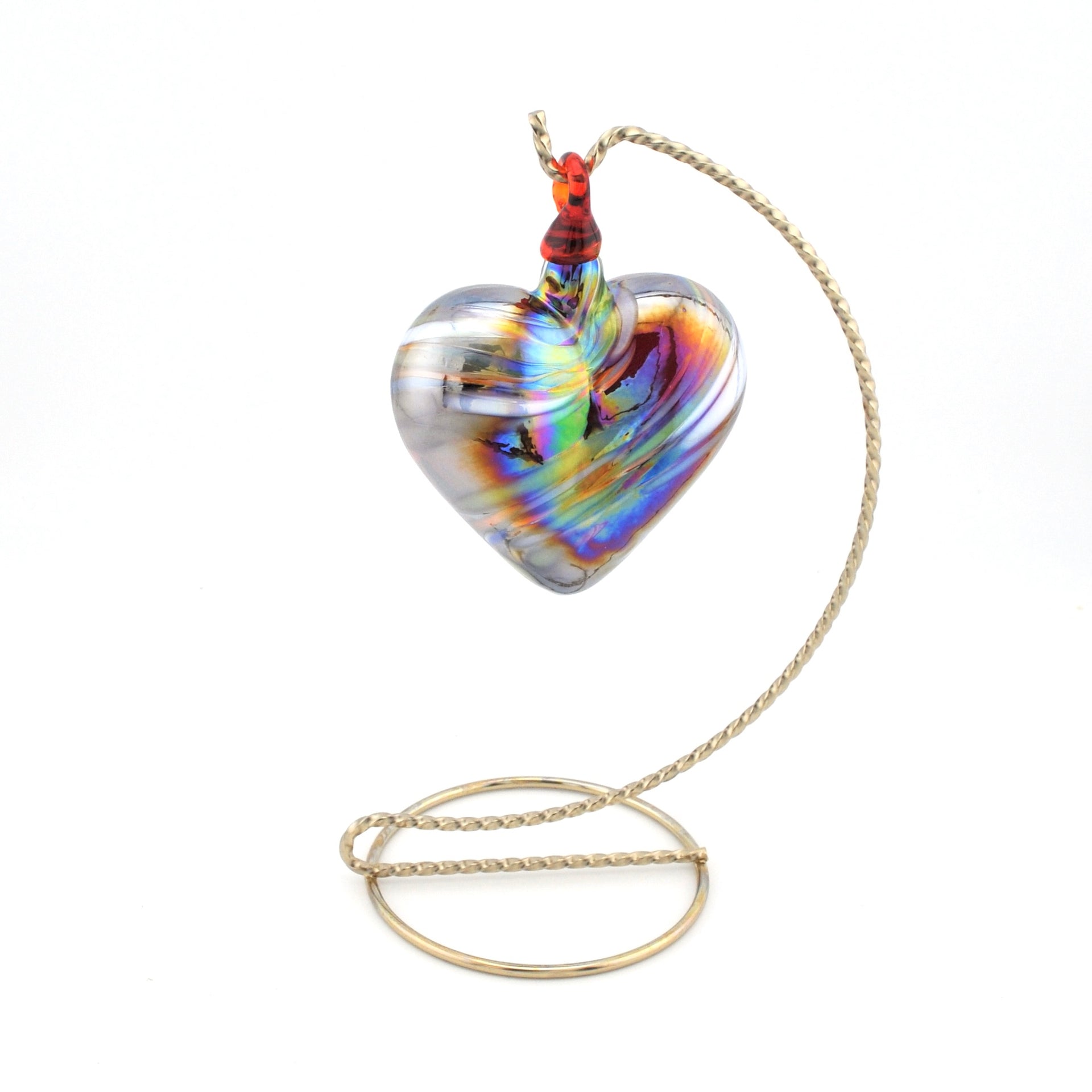 Heart-shaped glass pendant on a chain against a white background