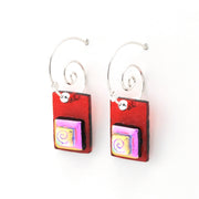 Red square earrings with colorful spiral design on a white background
