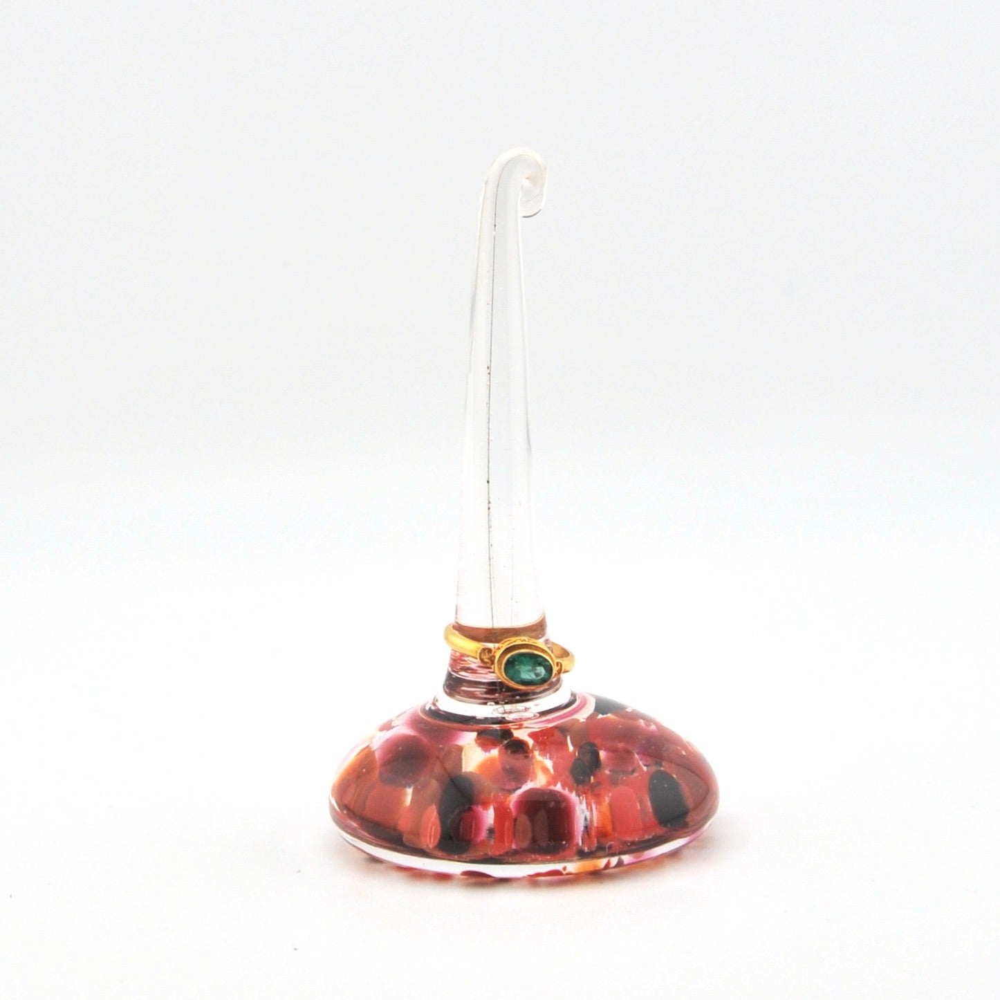Glass ring holder with a red and black pattern on a white background