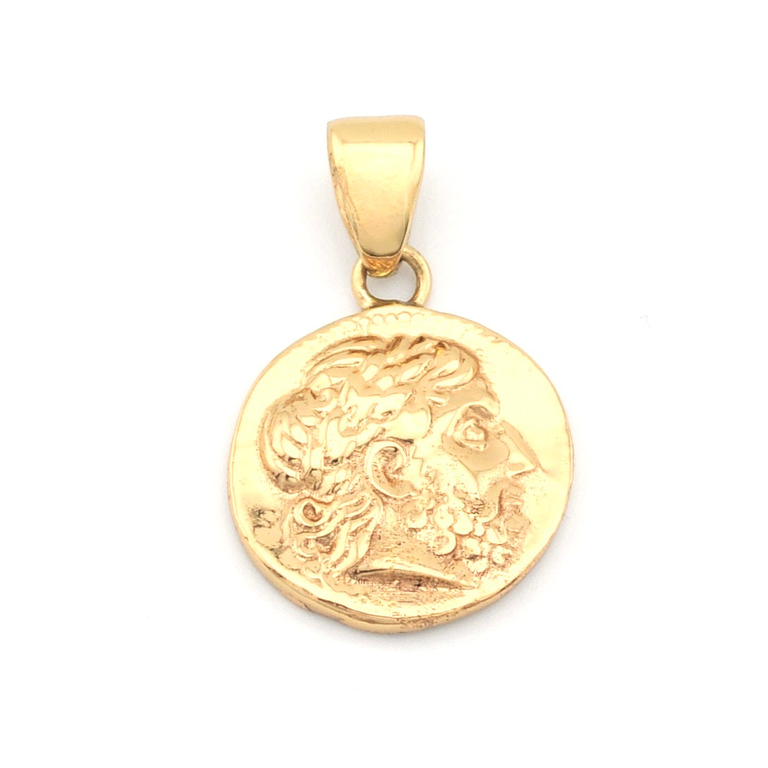 Gold pendant with a face design on a white background