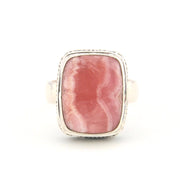 Ring with a pink stone and silver band on a white background