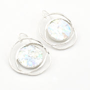 Silver hoop earrings with round, iridescent glass on a white background